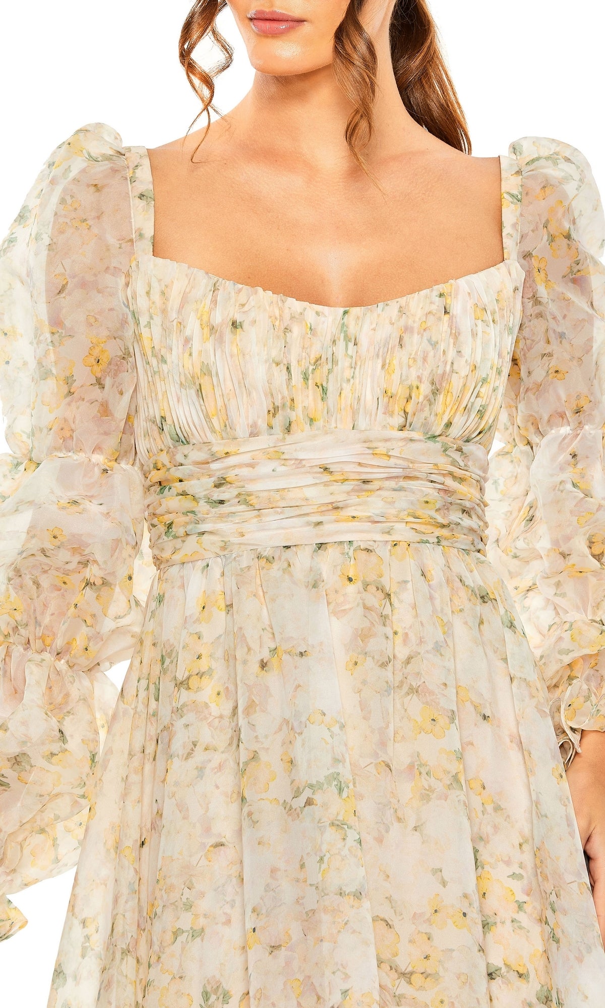 A woman wears the Long Formal Dress 68288 by Mac Duggal, featuring a light floral print, sheer puffed long sleeves, a square neckline, and a ruched empire waist for an elegant silhouette.